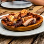 Galician style octopus with paprika, potatoes and olive oil in restaurant
