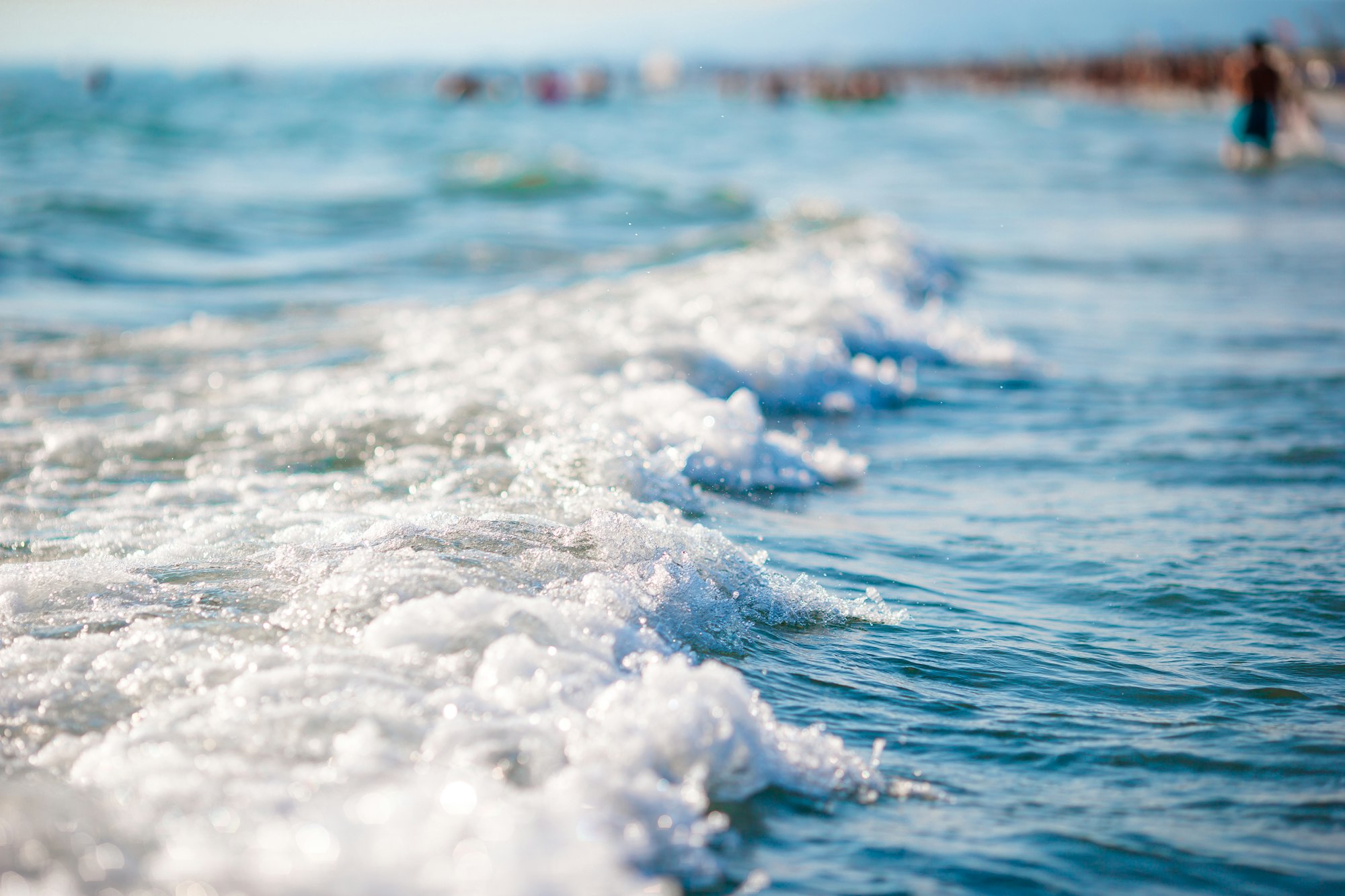The shimmering sun shines on the sea floor. Wild wave on the sea